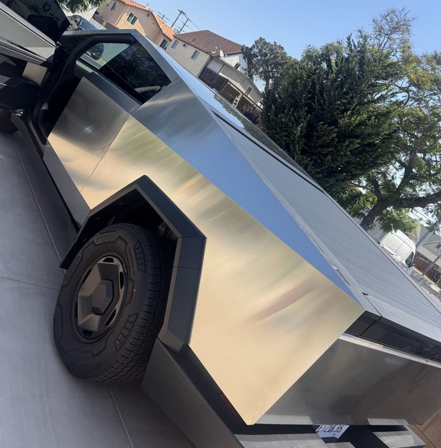 Tesla Cybertruck parked on a driveway with its door open during a mobile tire service call