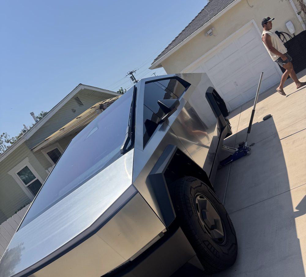 Tesla Cybertruck jacked up on a San Diego driveway during a Drop Mobile Tire Service call